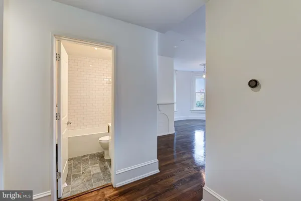 a bathroom with a glass shower door and a window