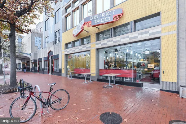 a glass building with table and chairs