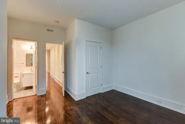 a view of hallway with wooden floor