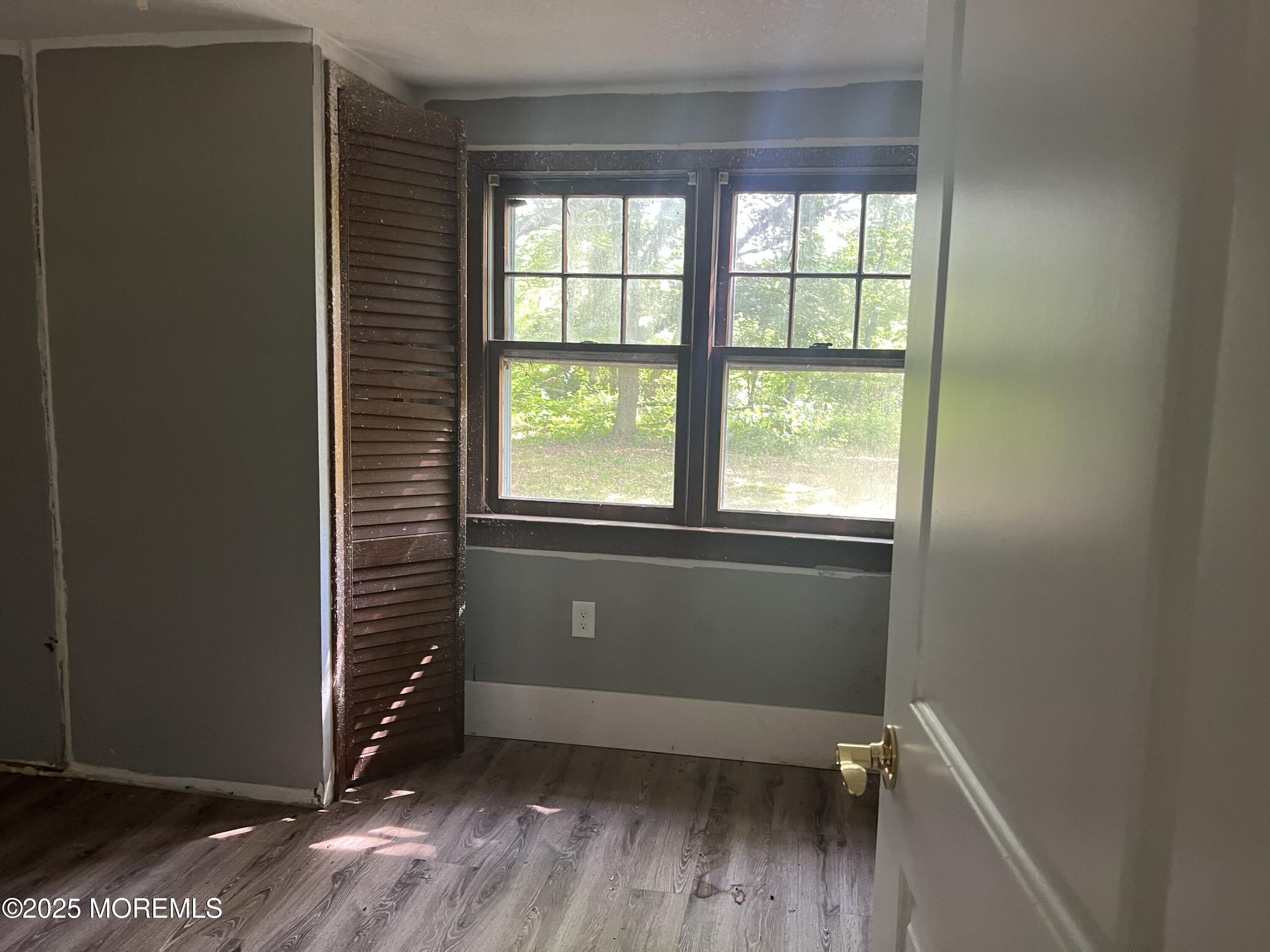 138 Disbrow Hill Road Millstone Township, NJ 08535 - Photo 11 of 33 an empty room with wooden floor and windows