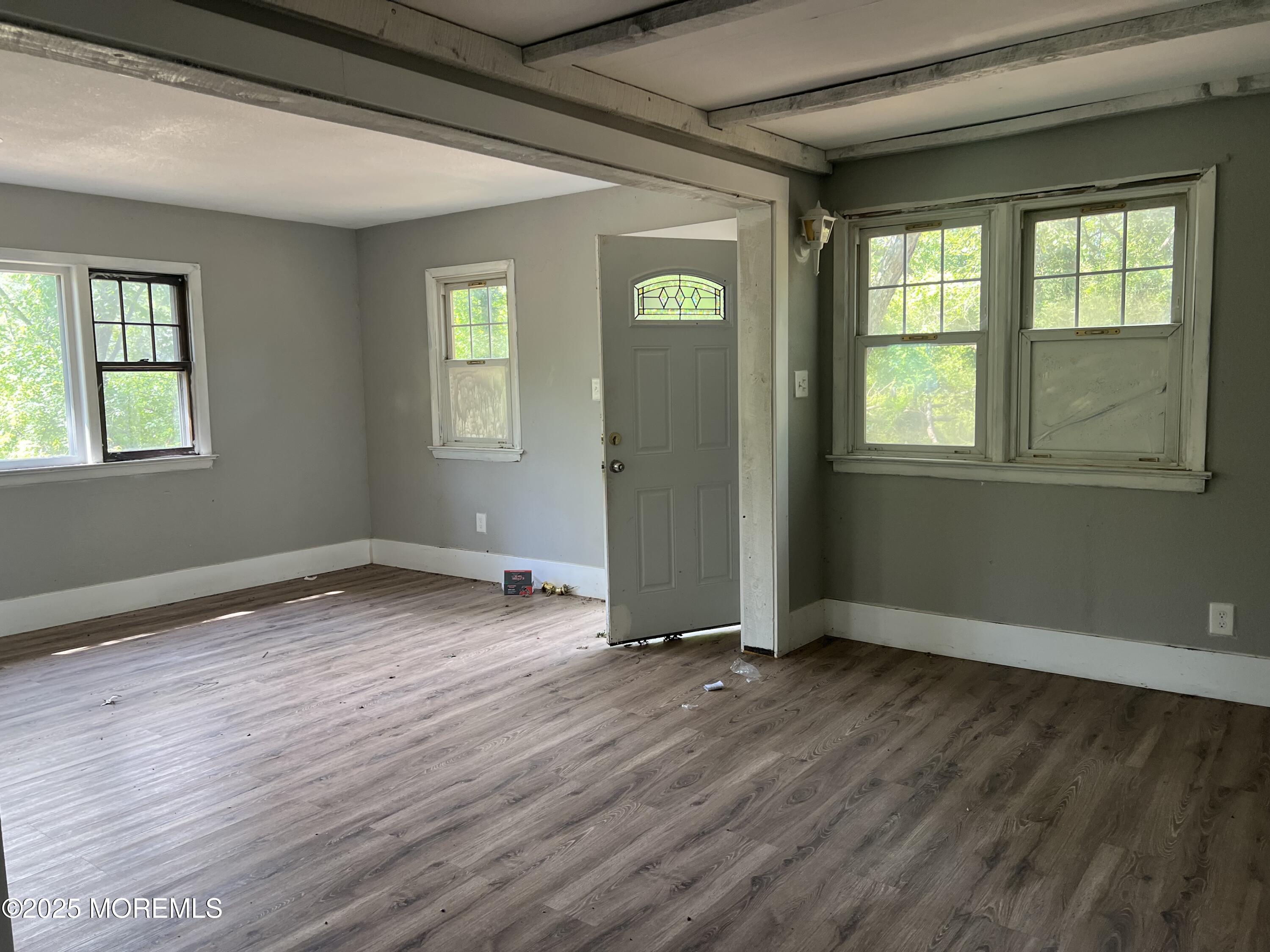 138 Disbrow Hill Road Millstone Township, NJ 08535 - Photo 13 of 33 an empty room with wooden floor and windows