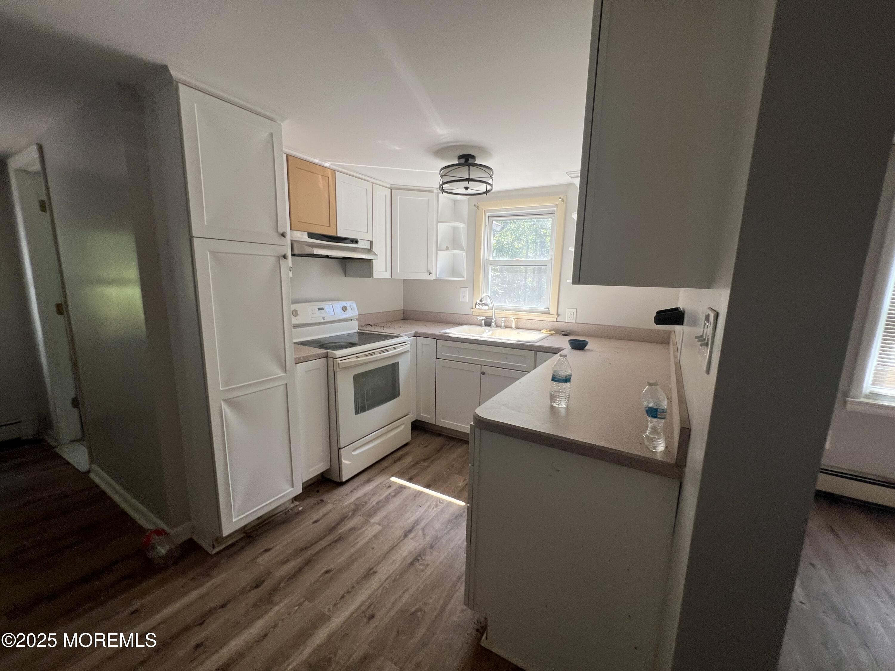 138 Disbrow Hill Road Millstone Township, NJ 08535 - Photo 14 of 33 a kitchen with a sink a refrigerator and washer
