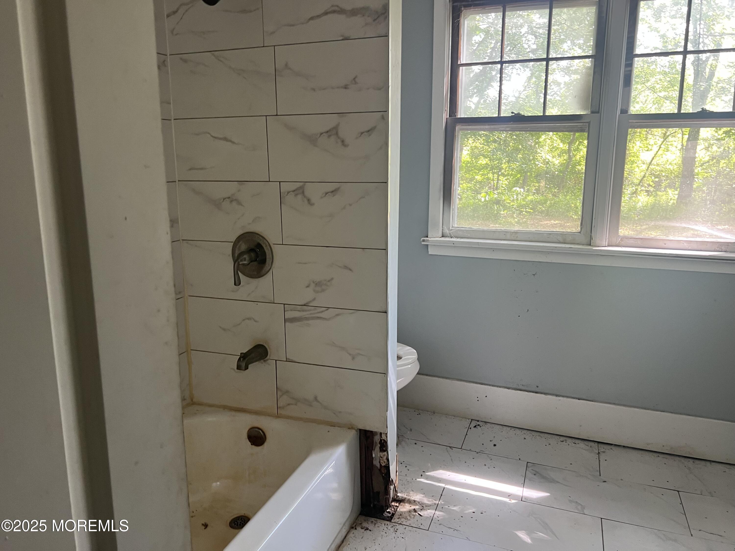 138 Disbrow Hill Road Millstone Township, NJ 08535 - Photo 19 of 41 a bathroom with a bathtub and window