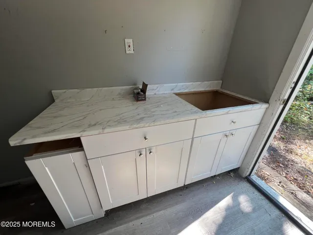 a bathroom with a granite countertop sink and vanity