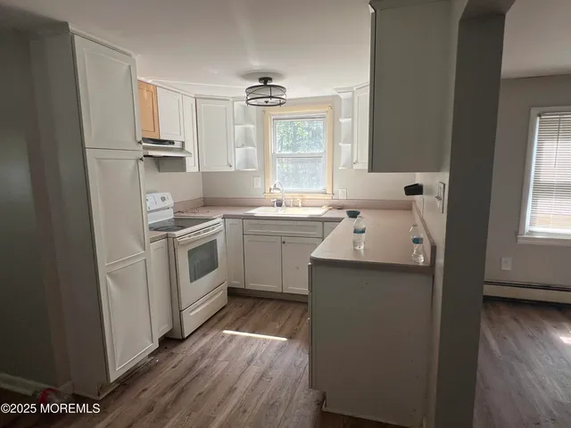 a kitchen with a sink stove and refrigerator