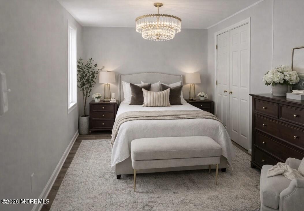 138 Disbrow Hill Road Millstone Township, NJ 08535 - Photo 26 of 41 a bedroom with a bed and chandelier