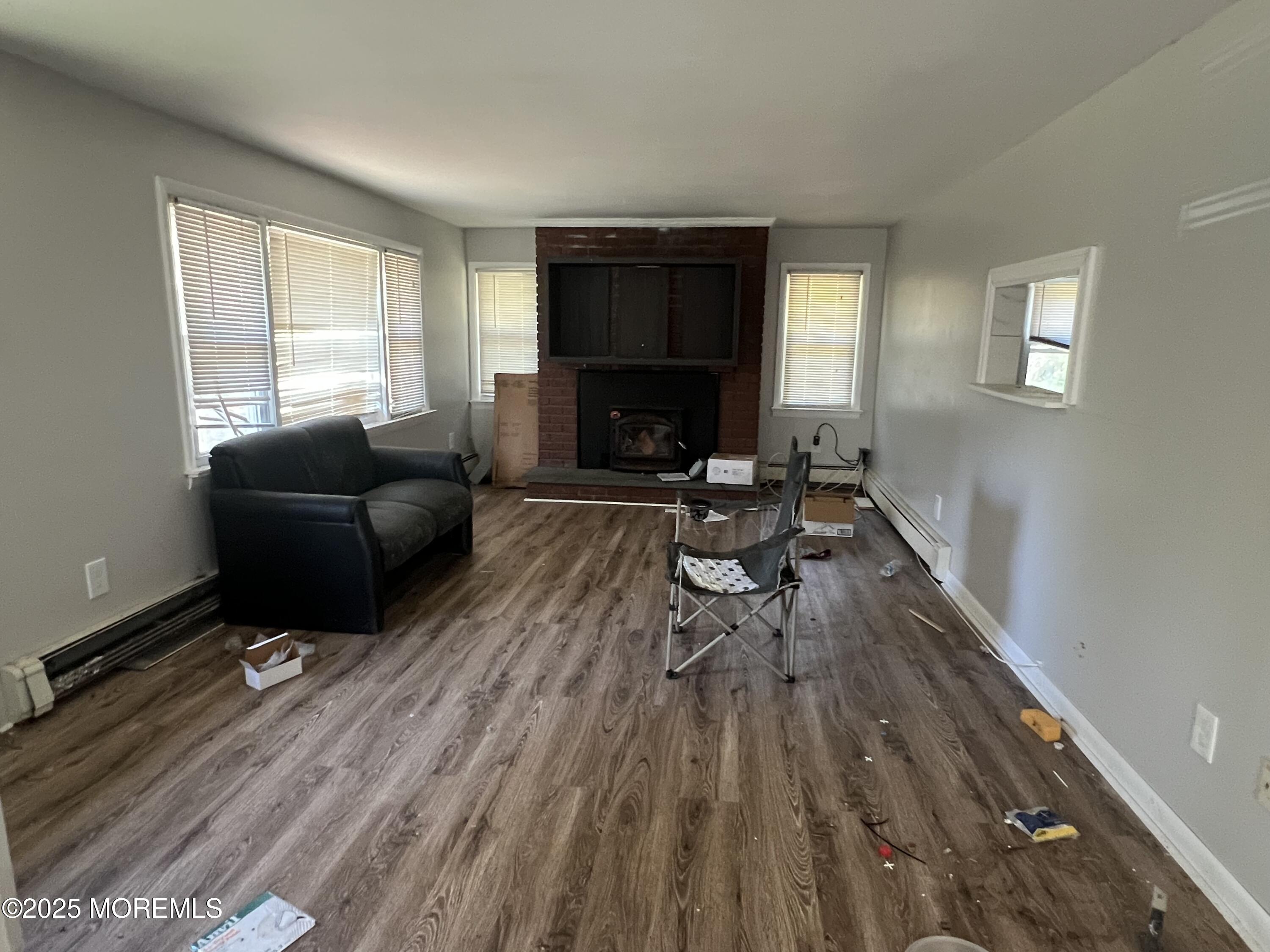 138 Disbrow Hill Road Millstone Township, NJ 08535 - Photo 27 of 33 a living room with furniture and a wooden floor