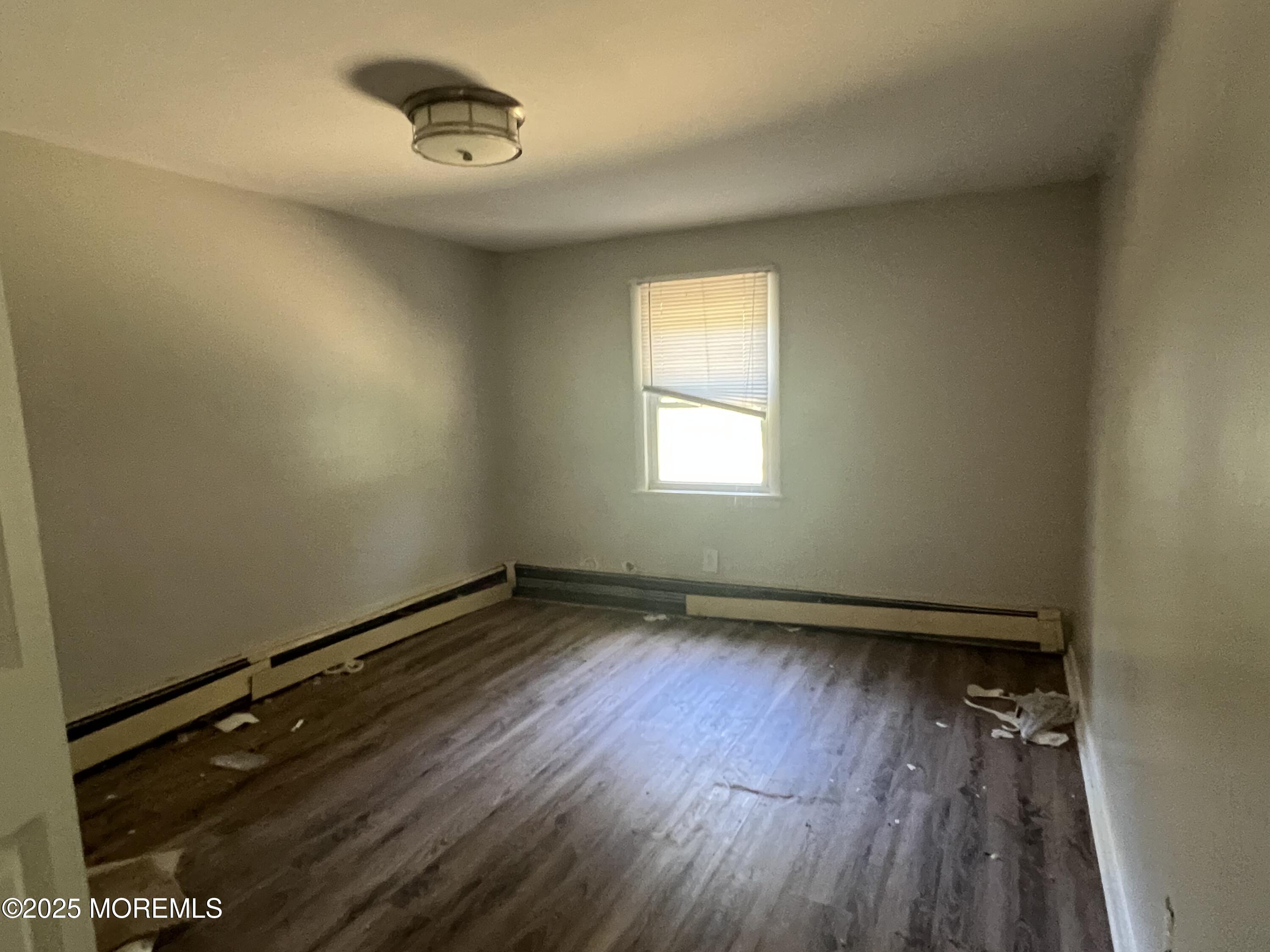 138 Disbrow Hill Road Millstone Township, NJ 08535 - Photo 30 of 33 an empty room with wooden floor and windows