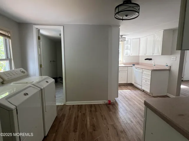a kitchen with sink cabinets and wooden floor