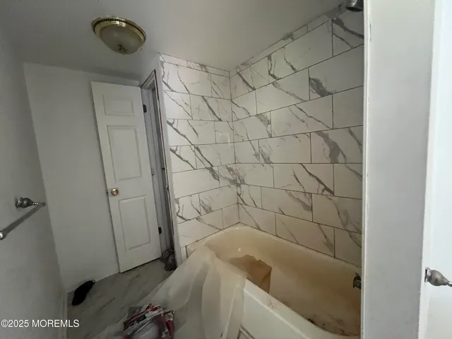 a bathroom with a bathtub and shower