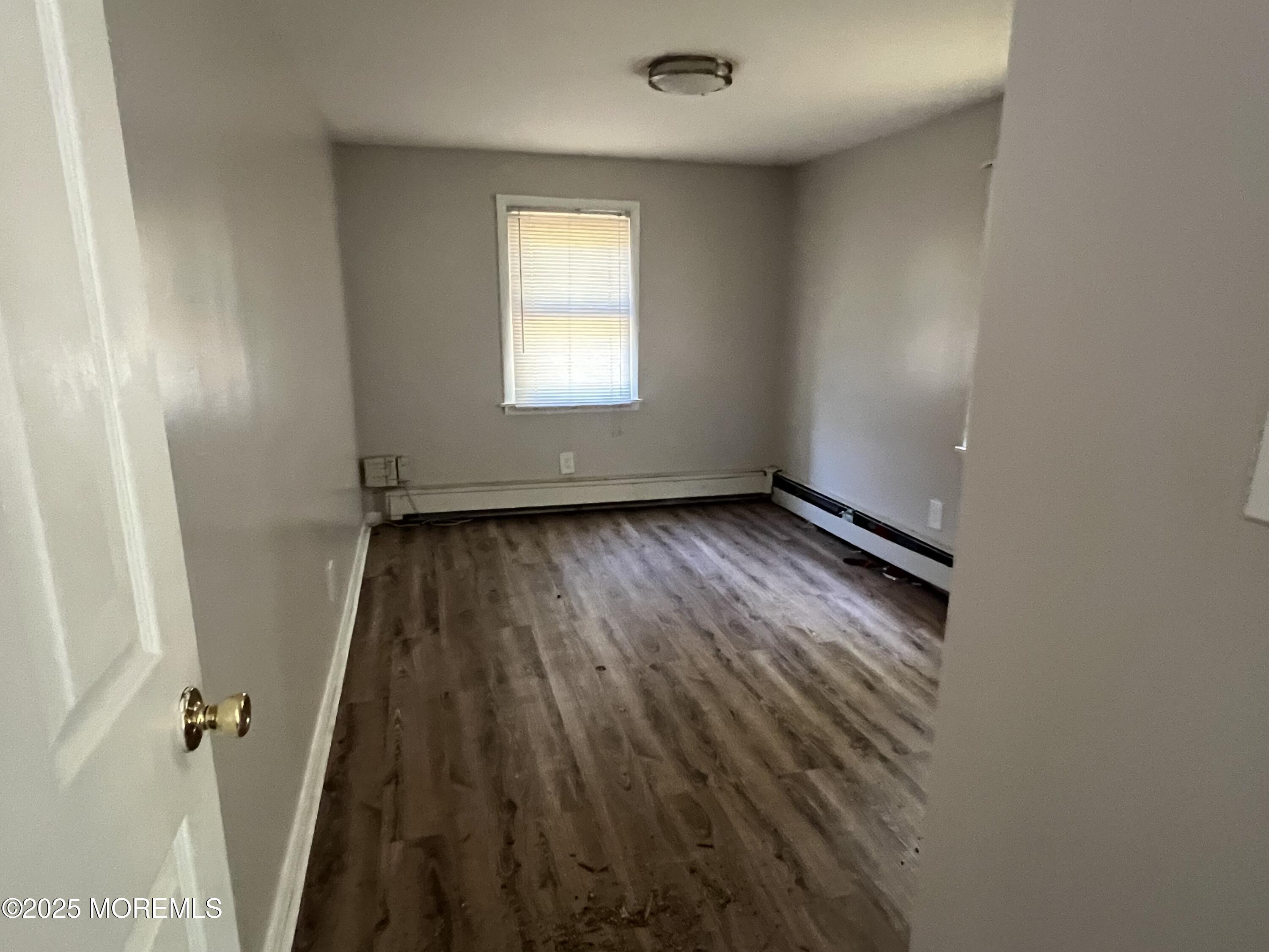 138 Disbrow Hill Road Millstone Township, NJ 08535 - Photo 40 of 41 an empty room with wooden floor and windows