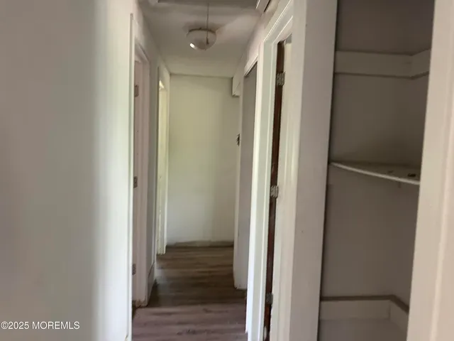 a view of a hallway with a wooden floor