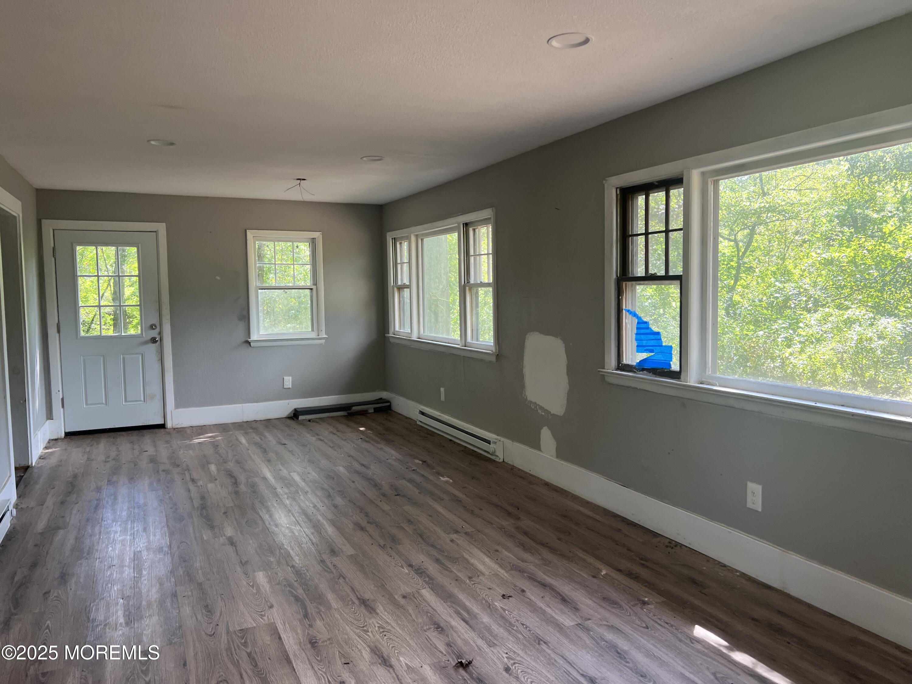 138 Disbrow Hill Road Millstone Township, NJ 08535 - Photo 8 of 41 a view of an empty room with wooden floor and a window