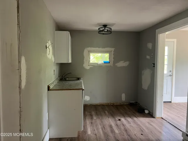 a kitchen with a wooden floor and a stove top oven