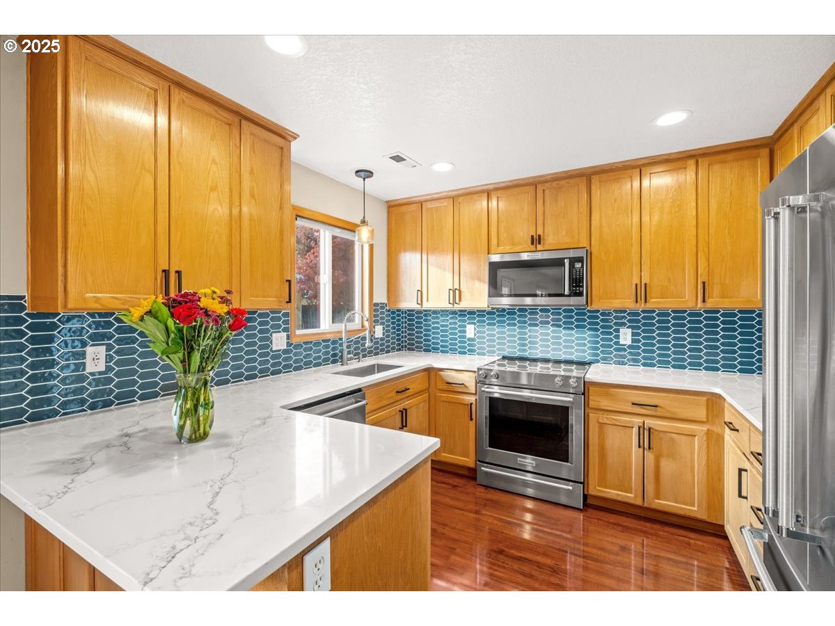 2108 B Street Forest Grove, OR 97116 - Photo 13 of 36 a kitchen with stainless steel appliances granite countertop sink stove and cabinets