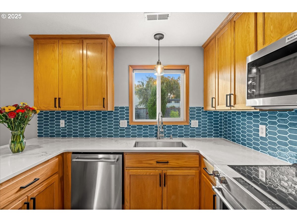 2108 B Street Forest Grove, OR 97116 - Photo 15 of 36 a kitchen with a sink a counter top space and cabinets