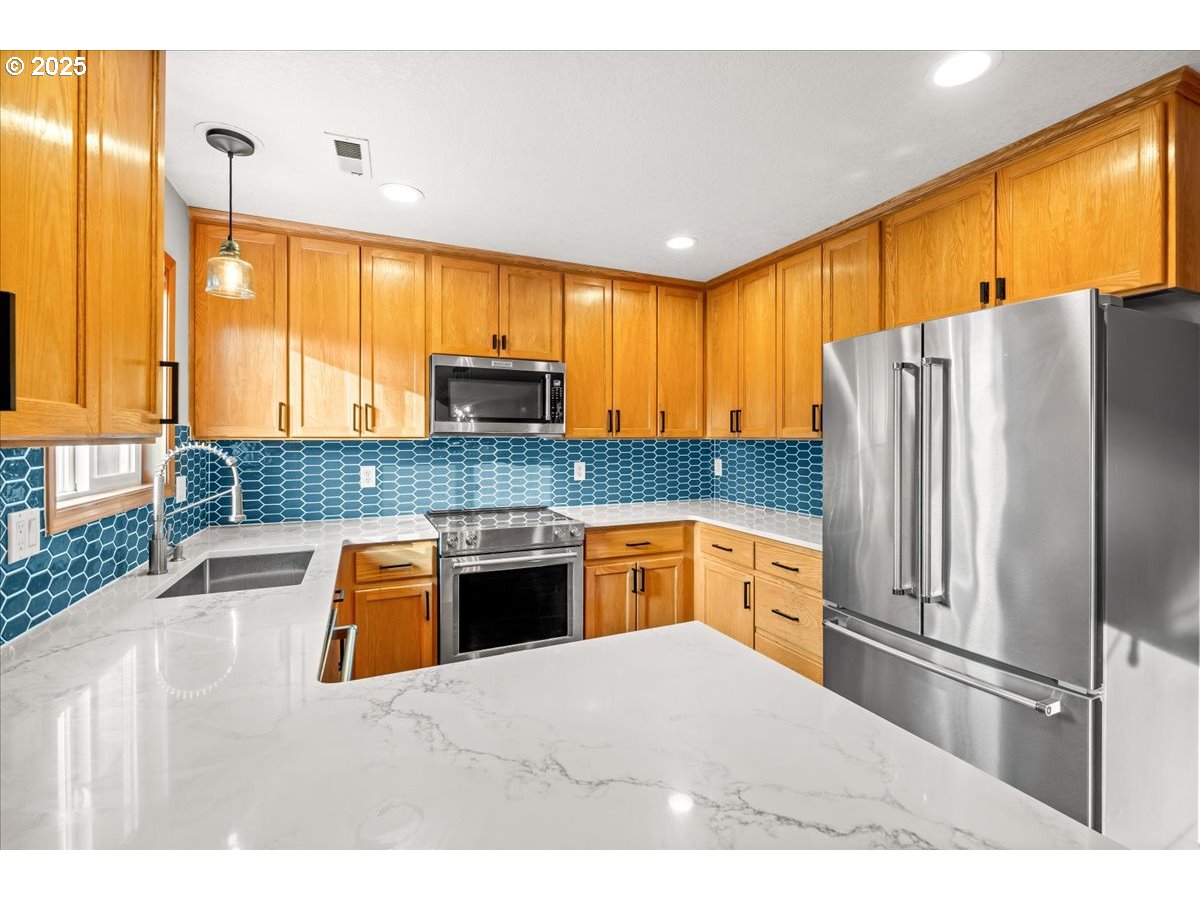 2108 B Street Forest Grove, OR 97116 - Photo 16 of 36 a kitchen with stainless steel appliances granite countertop a refrigerator a sink dishwasher a stove and a refrigerator