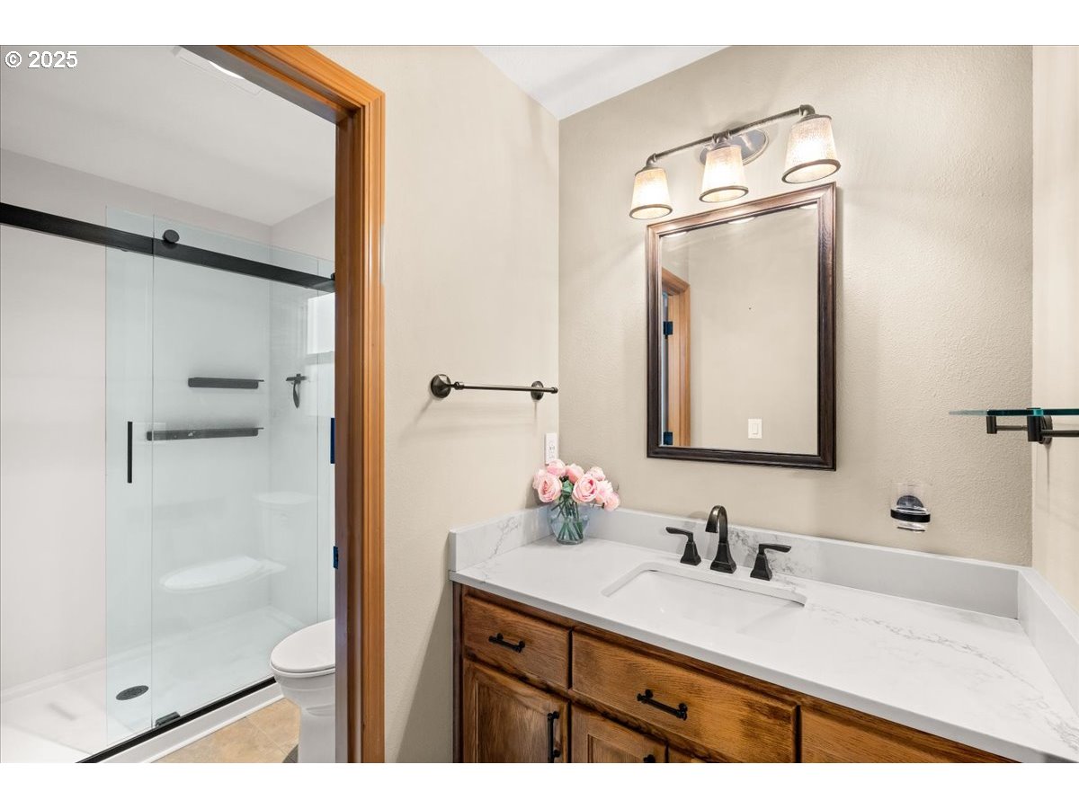 2108 B Street Forest Grove, OR 97116 - Photo 19 of 36 a bathroom with a sink vanity granite tub and a mirror