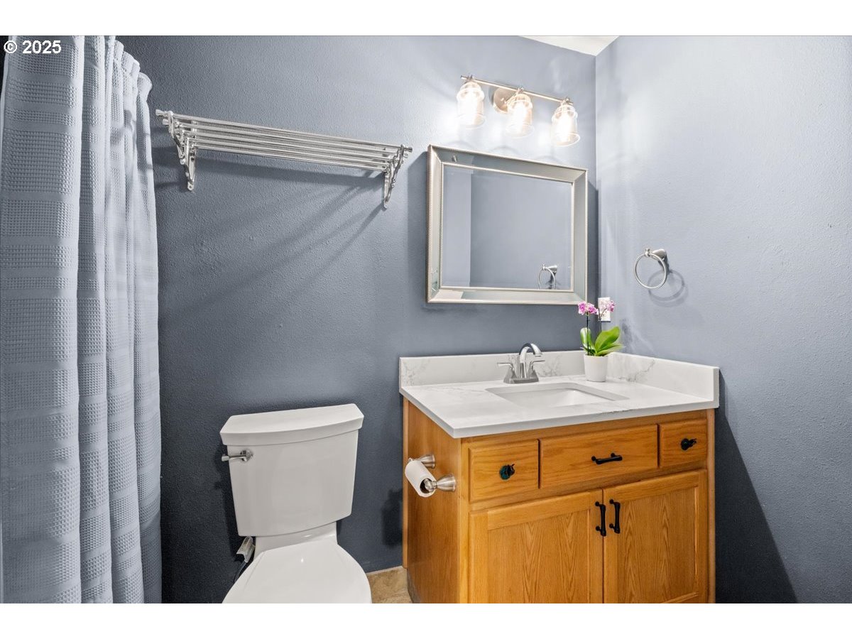 2108 B Street Forest Grove, OR 97116 - Photo 25 of 36 a bathroom with a sink a toilet and mirror