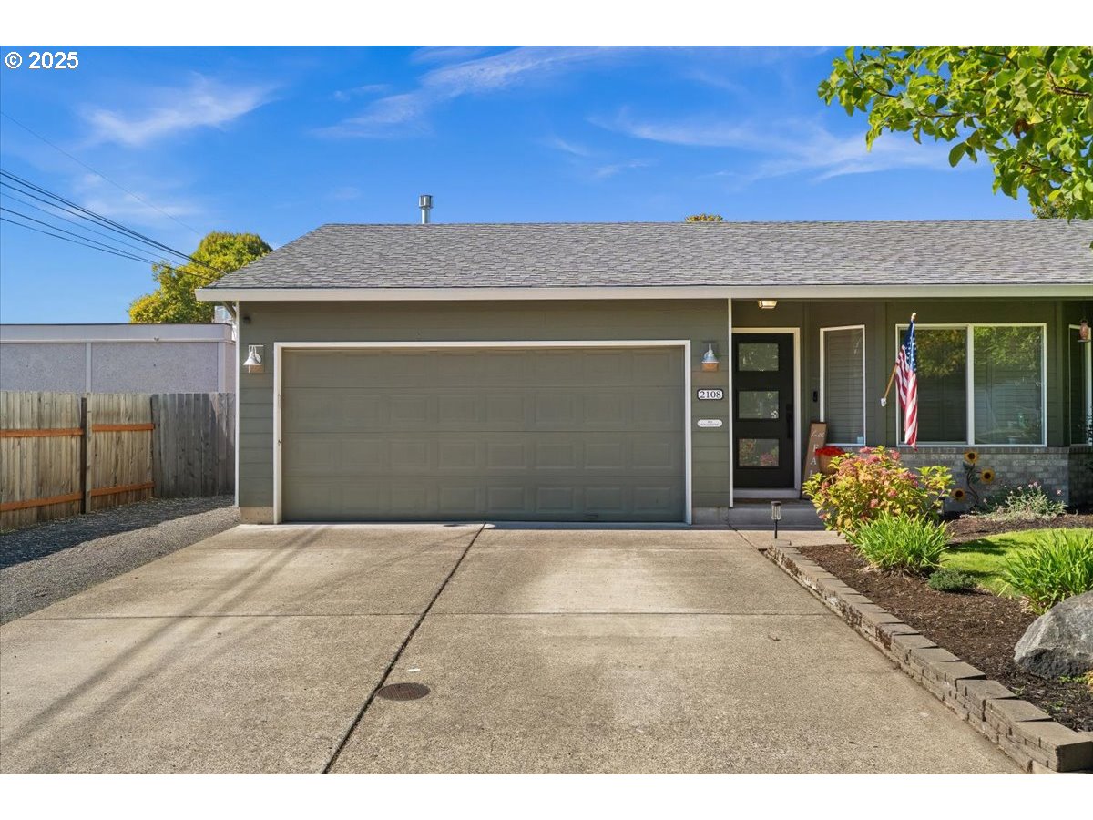 2108 B Street Forest Grove, OR 97116 - Photo 4 of 36 a front view of a house with a yard and garage
