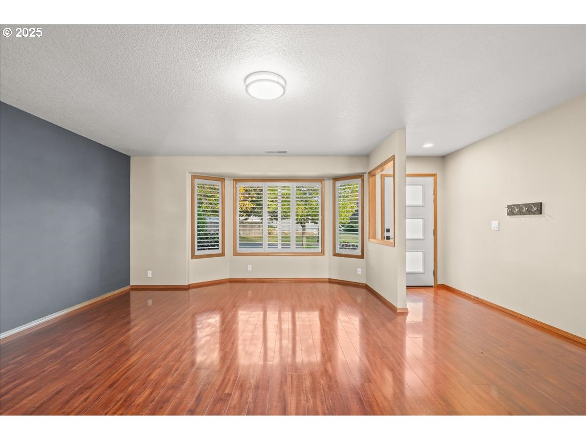 2108 B Street Forest Grove, OR 97116 - Photo 9 of 36 a view of an empty room with wooden floor and a window