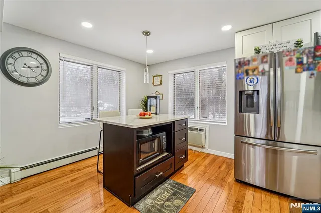 a kitchen with stainless steel appliances granite countertop a refrigerator and a stove top oven
