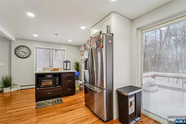 a kitchen with stainless steel appliances granite countertop a refrigerator and a stove top oven