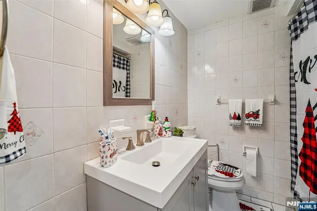 a bathroom with a sink mirror and toilet