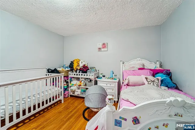 a bedroom with furniture and a baby crib