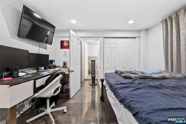 a bedroom with a bed and flat screen tv