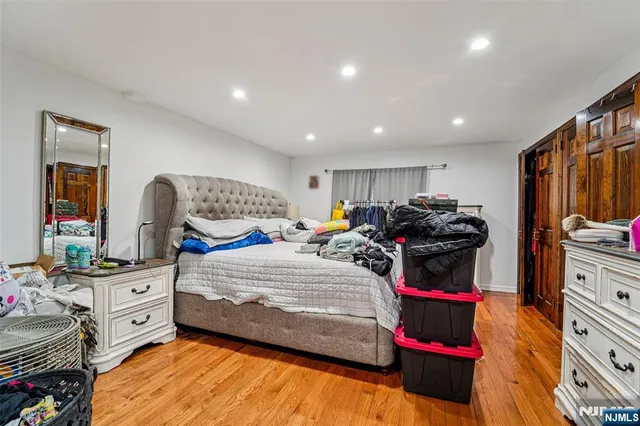 a bedroom with furniture and a mirror