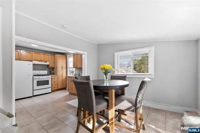 a view of a dining room with furniture and a window