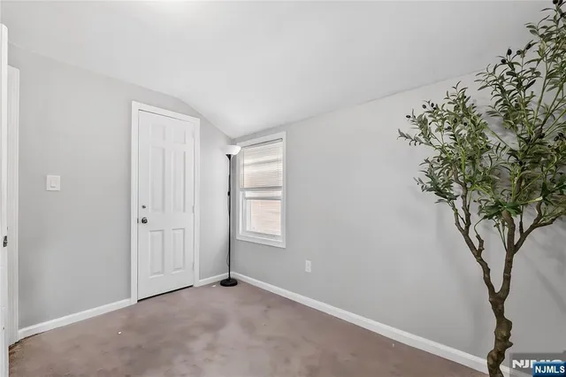 an empty room with windows and closet