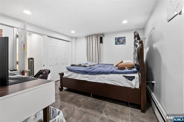 a bedroom with a bed and a large mirror