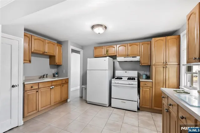 a kitchen with a stove sink and refrigerator