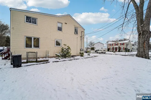 a view of a house with a snow on the road
