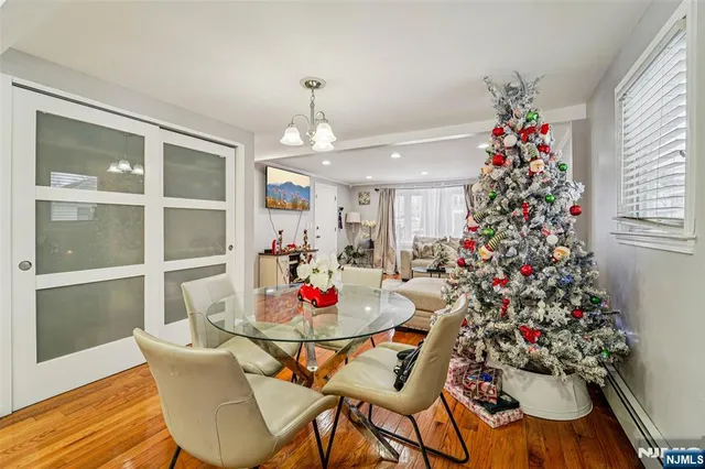 a view of a dining room with furniture and chandelier