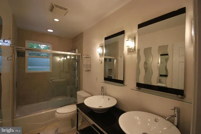 a bathroom with a toilet a sink and a mirror