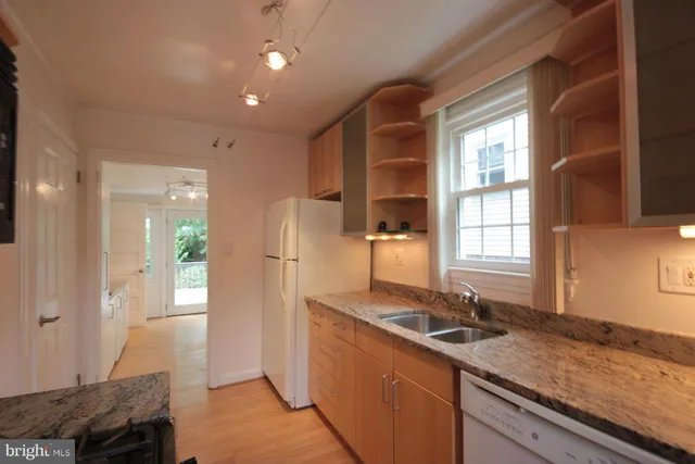 a kitchen with a sink stove and refrigerator