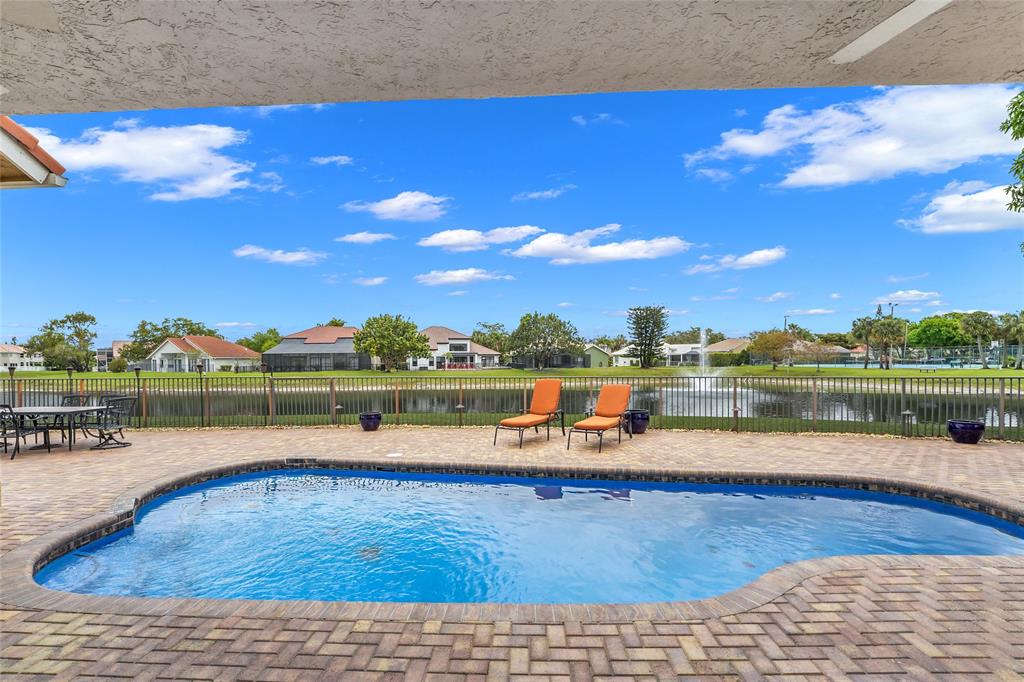 22280 Tupelo Place Boca Raton, FL 33428 - Photo 11 of 53 a view of swimming pool with lake view and mountain in the back