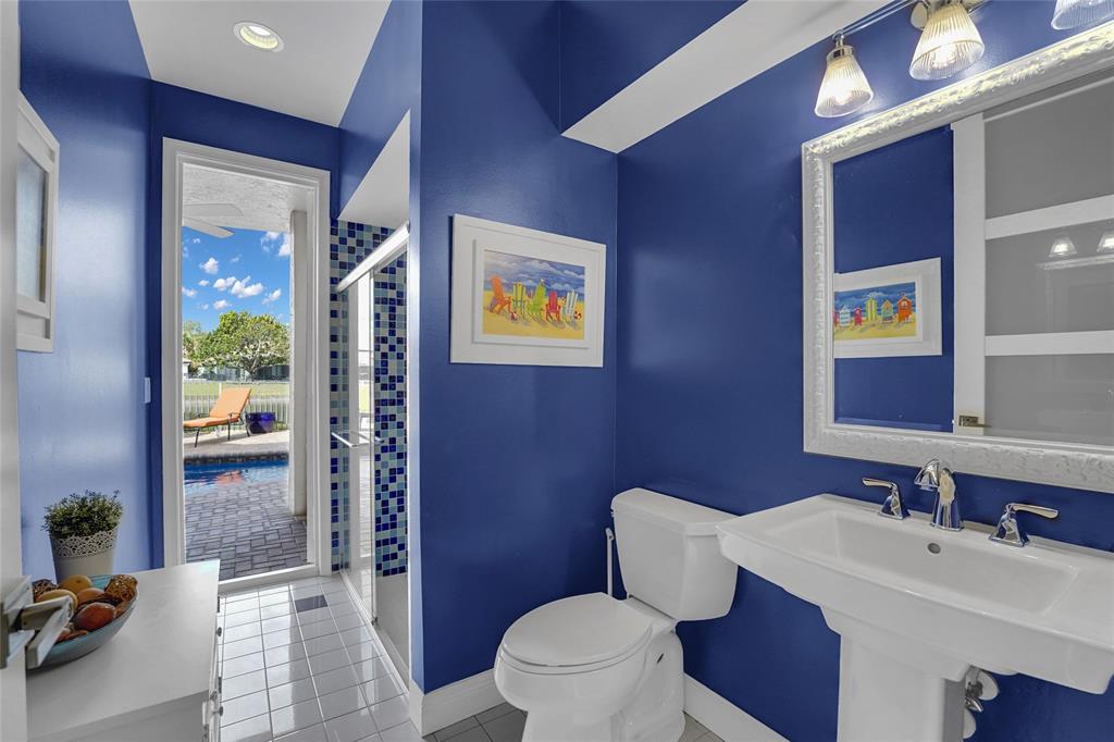 22280 Tupelo Place Boca Raton, FL 33428 - Photo 29 of 53 a bathroom with a toilet a sink and mirror