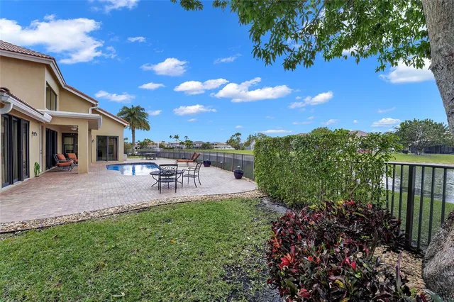 a view of a patio with chairs and a yard