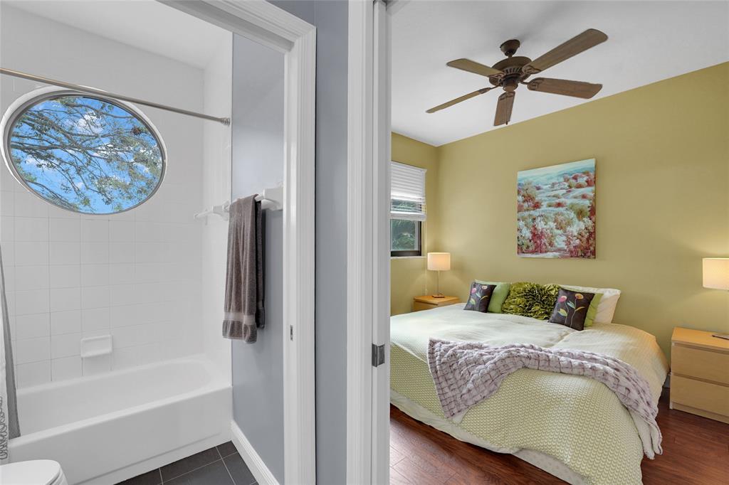 22280 Tupelo Place Boca Raton, FL 33428 - Photo 43 of 53 a bedroom with a large bed and a chandelier