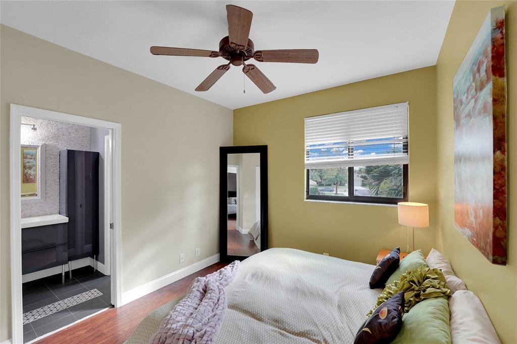 22280 Tupelo Place Boca Raton, FL 33428 - Photo 44 of 53 a bedroom with a bed and a chandelier