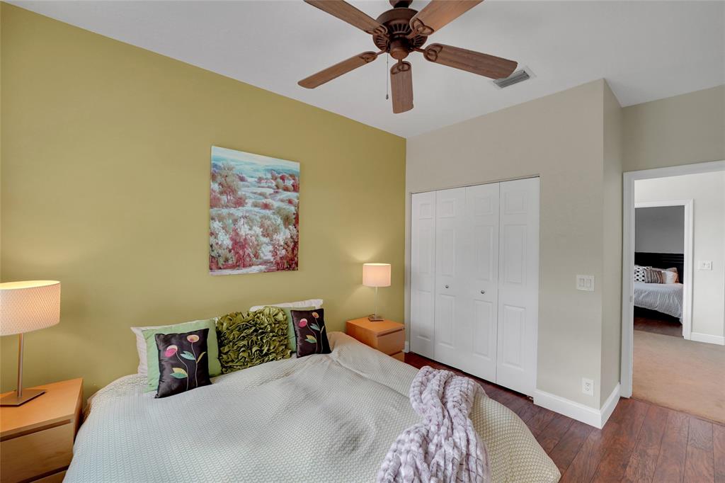 22280 Tupelo Place Boca Raton, FL 33428 - Photo 45 of 53 a bedroom with a bed and a painting on the wall