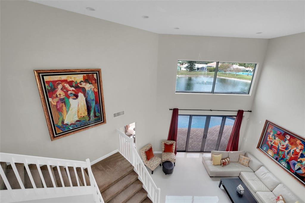 22280 Tupelo Place Boca Raton, FL 33428 - Photo 47 of 53 a living room with furniture and a baby crib