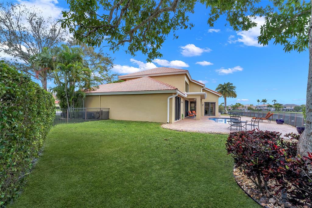 22280 Tupelo Place Boca Raton, FL 33428 - Photo 6 of 53 a front view of a house with a garden