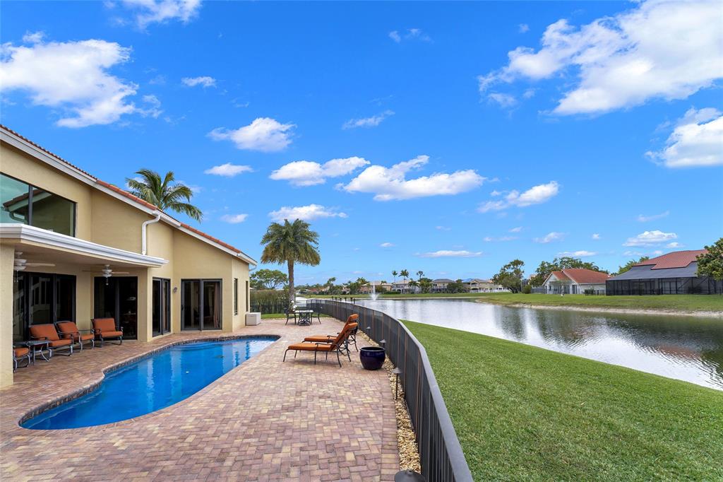 22280 Tupelo Place Boca Raton, FL 33428 - Photo 7 of 53 a view of a house with swimming pool and a yard