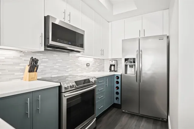 a kitchen with stainless steel appliances a refrigerator stove and sink