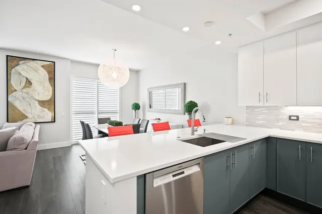 a kitchen with a sink a stove and cabinets